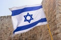 Israel Flag Against Western Wall in Jerusalem