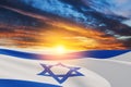 Israel flag with a star of David over cloudy sky background on sunset. Banner with place for text. Royalty Free Stock Photo