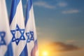 Israel flags with a star of David over cloudy sky background on sunset. Banner with place for text. Royalty Free Stock Photo