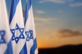 Israel flags with a star of David over cloudy sky background on sunset. Banner with place for text. Royalty Free Stock Photo