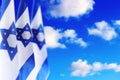 Israel flags with a star of David over cloudy sky background on sunset Royalty Free Stock Photo