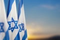 Israel flags with a star of David over cloudy sky background on sunset. Banner with place for text. Royalty Free Stock Photo