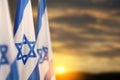 Israel flags with a star of David over cloudy sky background on sunset. Banner with place for text. Royalty Free Stock Photo