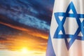 Israel flags with a star of David over cloudy sky background on sunset. Banner with place for text. Royalty Free Stock Photo