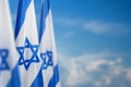 Israel flags with a star of David over cloudy sky background on sunset. Banner with place for text. Royalty Free Stock Photo