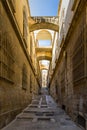 Israel, Jerusalem, View of a narrow street that rises with its unique stairs and the yellow stones of the old buildings