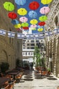 Israel-Jerusalem 12-05-2019 View of a terrace situated between the tall buildings, decorated with umbrellas and Israeli flags in t
