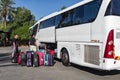 Israel Jerusalem 11-05-2019 View of a white touring car where people load suitcases into the loading space of the bus.