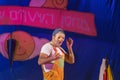 Israel, the Negev, Beer-Sheva - 2015 Hanukkah celebration in the youth theater. An actor wearing a mask