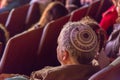 Israel, the Negev, Beer-Sheva -A man with a stack of color - in the audience, sitting back, 2015