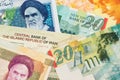 Israel Shekel and Iran Rial Currency banknotes close up image.