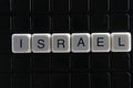 Israel text word title caption label cover backdrop background. Alphabet letter toy blocks on black reflective background. Royalty Free Stock Photo