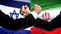 Israel vs Iran confrontation, countries disagreement, fists on flag background