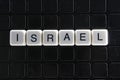 Israel white text word on black cover. Text word crossword. Alphabet letter blocks game texture background.