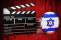 Israeli cinematography, film industry, cinema in Israel. Clapperboard with and film reels on the red fabric, 3D rendering