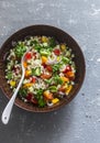 Israeli cous cous ptitim vegetables tabbouleh salad on a gray background, top view