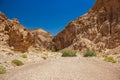 Israeli desert canyon passage way between sand stone rocky hills wasteland environment of Middle East