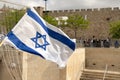 Israeli flag fluttered in the wind with the walls of the old city in the background Royalty Free Stock Photo