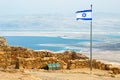 Israeli flag with the ruins on Masada with the Dead Sea on the b