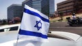 Israeli Flag waving in the wind on a car in honor of Yom Haatzmaut -Israeli Independence Day. Flag of Israel - national symbol