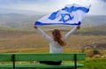 Israeli jewish little girl with Israel flag back view.