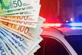 Israeli money notes banknotes and blue and red lights on top of police car in Israel Royalty Free Stock Photo