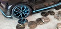 Israeli one shekel coin near Bugatti Chiron black metal toy with money reflection of the wheel