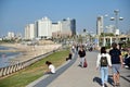 Israeli people walking along Tel Aviv beachfront promenade