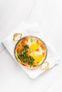 Israeli shakshuka on a white background