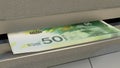 50 Israeli shekels in cash dispenser. Withdrawal of cash from an ATM. ILS. 3d render.