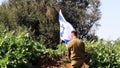 Israeli soldier mournfully bowed his head to the Flag of Israel, and then saluted the Flag in memory of the dead
