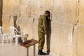 Israeli soldier praying in front of Sacred Western Wall in Jerusalem Old City Jewish Temple