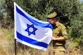 Israeli soldier, staff sergeant, kisses the Flag of Israel. Concept: Tzahal (IDF), Israel Independence Day Royalty Free Stock Photo