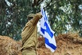 Israeli Soldier salutes the flag of Israel on top of a mountain. Concept: Soldiers Tzahal, Israel Defense Forces, IDF Royalty Free Stock Photo
