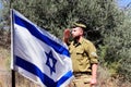 Israeli soldier salutes the Israel Flag on the holiday Yom Haatzmaut - Israel Independence Day Royalty Free Stock Photo