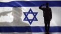 Israeli soldier silhouette saluting against national flag, terrorism prevention