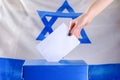 Israeli Young woman putting a ballot in a ballot box on election day Royalty Free Stock Photo