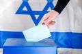 Israeli Young woman putting a ballot in a ballot box on election day.