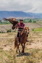 ISSYK KUL, KYRGYZSTAN - JULY 15, 2018: Local hunter with his eagle at the Ethnofestival Teskey Jeek at the coast of