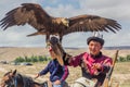 ISSYK KUL, KYRGYZSTAN - JULY 15, 2018: Local man with his eagle at the Ethnofestival Teskey Jeek at the coast of Issyk