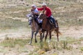 ISSYK KUL, KYRGYZSTAN - JULY 15, 2018: Performance of kyz kuuma girl chasing , equestrian traditional sport at the