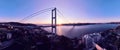 Istanbul Bosphorus Bridge and City Skyline in Background with Turkish Flag at Beautiful Sunset, Aerial slide orbiting Royalty Free Stock Photo