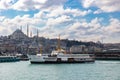 Istanbul. Ferry and Suleymaniye Mosque view with cloudy sky