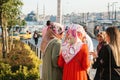 Istanbul, June 15, 2017: Islamic women in traditional attire communicate with each other and wait for a taxi on the