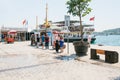 Istanbul, June 17, 2017: Two girls friends met and show each other something on the mobile phone. Nearby people are