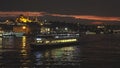 Travel touristic ship in Golden Horn on a background of evening light Istanbul cityscape with Suleymaniye mosque at