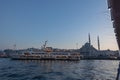 Istanbul photo. Ferry and Yeni Cami aka New Mosque in Eminonu district at sunset Royalty Free Stock Photo