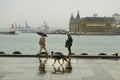 Istanbul steamboat pier people walking in the rain.