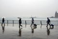Istanbul steamboat pier people walking in the rain.