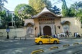 Istanbul street with a yellow taxi and tourists having a brisk walk